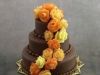 Chocolate three-tiered wedding cake in fall colors