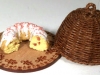 Bundt cake on wooden plate with basket cover